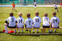 Kids Sitting on a Soccer Bench e1604037447847